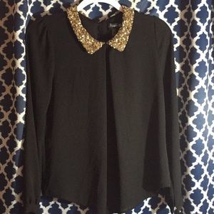 Gold collared black blouse